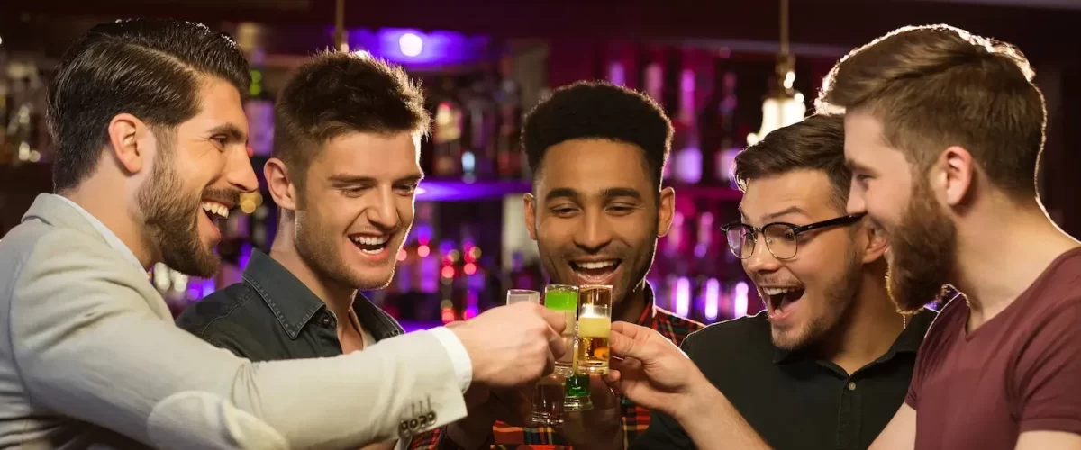 happy-male-friends-drinking-beer-clinking-glasses